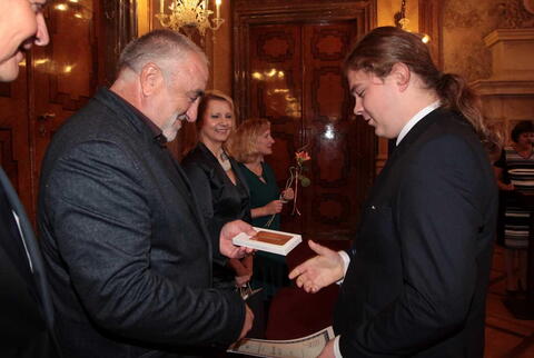 Věcnou cenu v soutěži Mladý řemeslník předává Vítkovi pan senátor Petr Šilar.